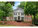 Charming two-story traditional home with a manicured lawn and mature trees at 790 Thornberry Dr, Alpharetta, GA 30022