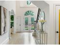 Bright foyer showcases arched doorway, hardwood floors, double glass doors and staircase at 790 Thornberry Dr, Alpharetta, GA 30022