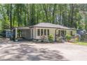 Charming, one-story home with a well-manicured lawn, carport, and extra storage at 1992 Cascade Sw Rd, Atlanta, GA 30311