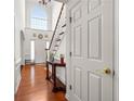 Bright entryway with hardwood floors, white staircase, and a soaring arched window at 10 Bunker Lane St, Covington, GA 30014
