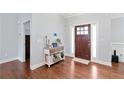 Welcoming foyer with hardwood floors, a decorative table, and a charming front door at 505 Alta Ct, Villa Rica, GA 30180