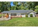 Lovely brick home featuring a long carport, updated windows, and a quaint, elevated wood deck at 1345 Sw Dodson Dr, Atlanta, GA 30311