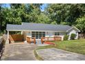 Inviting ranch-style home with updated windows, a brick facade, and a cozy, elevated wood deck at 1345 Sw Dodson Dr, Atlanta, GA 30311