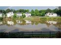 Scenic pond view with a rainbow, surrounded by lush green trees and beautiful houses at 1692 Holcomb Lake Rd, Marietta, GA 30062