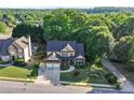 Inviting two-story home featuring a well-manicured lawn, attached two-car garage, and mature trees at 2978 Legislative Ln, Buford, GA 30519