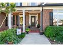 Inviting front porch with brick accents and a cozy seating area, perfect for relaxing at 2978 Legislative Ln, Buford, GA 30519