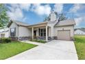Inviting home with a covered porch, attached garage, and a neatly paved driveway at 6755 Biscayne Blvd, Rex, GA 30273
