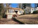 Charming single-Gathering home with a tidy front yard and an unfinished basement garage at 1235 Westboro Sw Dr, Atlanta, GA 30310
