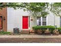 Close-up exterior showing front door with a vibrant red door, complemented by neat shrubs and siding at 238 Chads Ford Way, Roswell, GA 30076