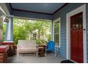 Cozy front porch with seating, a birdhouse, and a charming view of the landscaped yard at 959 Berne Se St, Atlanta, GA 30316