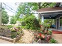 Beautiful front yard with lush landscaping, flowers, and a charming stone walkway leading to the porch at 959 Berne Se St, Atlanta, GA 30316