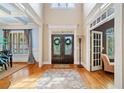 Grand foyer with hardwood floors, high ceilings, and elegant staircase at 106 Stephens Farm Dr, Canton, GA 30115