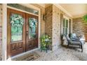 Inviting front porch with double doors, brick accents, and seating area at 106 Stephens Farm Dr, Canton, GA 30115