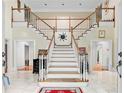 Elegant foyer showcasing a grand staircase and marble flooring at 5105 Jett Forest Trl, Atlanta, GA 30327