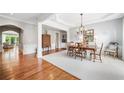Elegant dining room with hardwood floors and sophisticated chandelier lighting at 1435 Harburn Ct, Cumming, GA 30041
