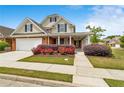 Beautiful home with a brick and tan exterior, complemented by well-maintained landscaping and a covered entry at 2055 Hickory Station Cir, Snellville, GA 30078