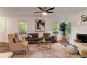 Bright living room with fireplace, stylish furnishings, and natural light at 607 Hickory Creek Ln, Woodstock, GA 30188