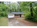 A cozy brick house with a well-maintained lawn and an attached garage providing convenient parking at 980 Oakton Sw Dr, Marietta, GA 30060