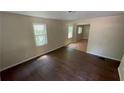 Bright living room featuring hardwood floors and natural light streaming through the large window at 2888 Mountain View Rd, Snellville, GA 30078