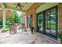 Charming covered porch with stone flooring, rocking chairs, and lush landscaping at 4311 N Elizabeth Se Ln, Atlanta, GA 30339