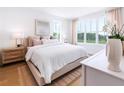 Bright bedroom with large windows, hardwood floors, a comfortable bed, and neutral décor at 506 Motivation Nw Cir, Atlanta, GA 30309