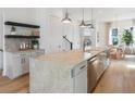 Bright kitchen featuring a large center island, stainless steel appliances and hardwood floors throughout at 506 Motivation Nw Cir, Atlanta, GA 30309