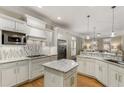 Bright kitchen features white cabinetry, stainless steel appliances, granite countertops, and a decorative backsplash at 2871 Parkridge Ne, Brookhaven, GA 30319