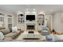 Cozy living room with fireplace, built-in shelving, and ample seating at 2871 Parkridge Ne, Brookhaven, GA 30319