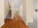 Inviting entryway with gleaming hardwood floors, staircase, and views into other living spaces at 3270 Golfe Links Dr, Snellville, GA 30039