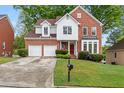 Beautiful two-story brick home with attached two-car garage and well-manicured lawn at 3270 Golfe Links Dr, Snellville, GA 30039