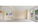 Bright living room featuring large bay windows, neutral carpet, and ample natural light at 3270 Golfe Links Dr, Snellville, GA 30039