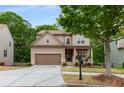 Lovely two-story home with a covered porch, attached garage, and a well-manicured front yard at 4876 Briarcliff Dr, Sugar Hill, GA 30518