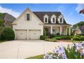 Traditional white brick home with a covered front porch, two-car garage, and well-maintained landscaping at 1021 Bluffhaven Ne Way, Atlanta, GA 30319