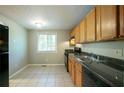 Bright kitchen with oak cabinets, a double sink, and views of the surrounding greenery at 1051 S Millard Way, Stone Mountain, GA 30088