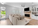 Bright living room with a fireplace, built-in bar, and a comfortable couch at 300 Olmstead Way, Alpharetta, GA 30022