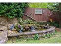 Relaxing backyard pond with rock waterfall and serene landscaping in a secluded outdoor space at 68 Edwin Pl Nw, Atlanta, GA 30318