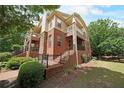 An appealing multi-story brick home featuring stone accents, multiple balconies, and a neatly landscaped front yard at 718 Province Se Pl, Atlanta, GA 30312