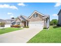 Well-kept home with a driveway, green lawn, and tasteful landscaping at 3322 Grace Farm Ln, Buford, GA 30519