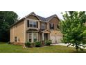 Attractive two-story home with neutral siding, brick accents, and an attached two-car garage at 6816 Diamond Dr, Rex, GA 30273