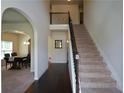 Inviting foyer with high ceilings, an elegant staircase, and arched doorways leading to the dining room at 6816 Diamond Dr, Rex, GA 30273