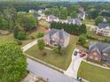 Well-manicured lawn surrounds this beautiful two-story brick home featuring a side entry garage and mature trees at 1032 Jordan Rd, Dacula, GA 30019