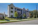 Townhome showcasing multi-tone siding, front lawn and proximity to street at 1899 Deco Dr, Kennesaw, GA 30144