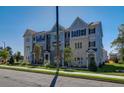 Townhome showing multi-tone siding and brick facade, front lawn and proximity to street at 1899 Deco Dr, Kennesaw, GA 30144