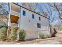 White two-story home with a balcony, white garage door, and tidy landscaping at 625 Home Se Ave, Atlanta, GA 30312