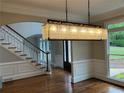 Dining area featuring hardwood floors, wainscoting, and a modern rectangular chandelier at 870 Thornberry Dr, Alpharetta, GA 30022