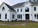 Elegant white two-story home featuring a manicured lawn and beautifully landscaped front yard at 870 Thornberry Dr, Alpharetta, GA 30022