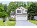 Charming two-story home with a well-manicured lawn, inviting curb appeal, and attached two-car garage at 1029 Megan Ct, Sugar Hill, GA 30518