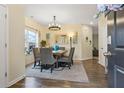 Traditional dining room with decorative chandelier, neutral walls and floors, and an adjacent door to the living room at 59 Summer Nw Pl, Cartersville, GA 30121