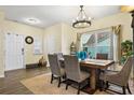 Bright dining room featuring a wooden table, upholstered chairs, and a contemporary chandelier at 59 Summer Nw Pl, Cartersville, GA 30121