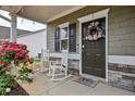 Inviting front porch with rocking chairs, decorative wreath, and stone accents creating a welcoming entrance at 59 Summer Nw Pl, Cartersville, GA 30121